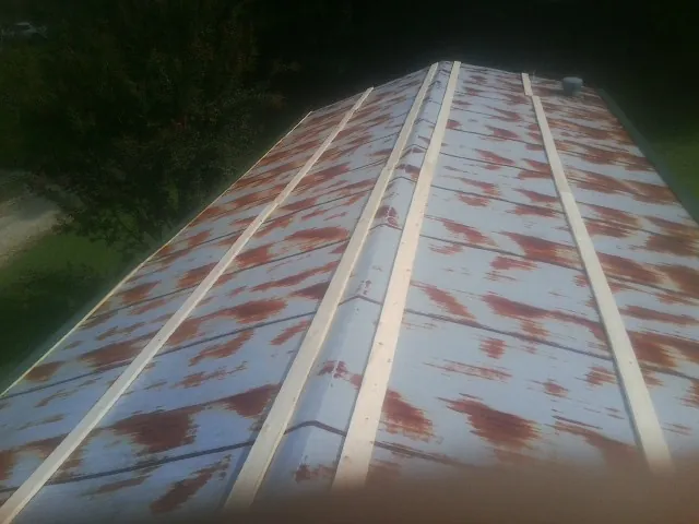 Rusted metal roof panels with new wood purlins before replacement — Storm Damage Roof Repair in Perth Amboy by Roofing Brothers